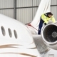 Person Working On Aeroplane In Hangar