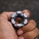 Close Up Of A Rugged Castle Nut Held By A Technician