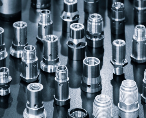 Close Up Of Various Metallic Threaded Fasteners On Dark Surface